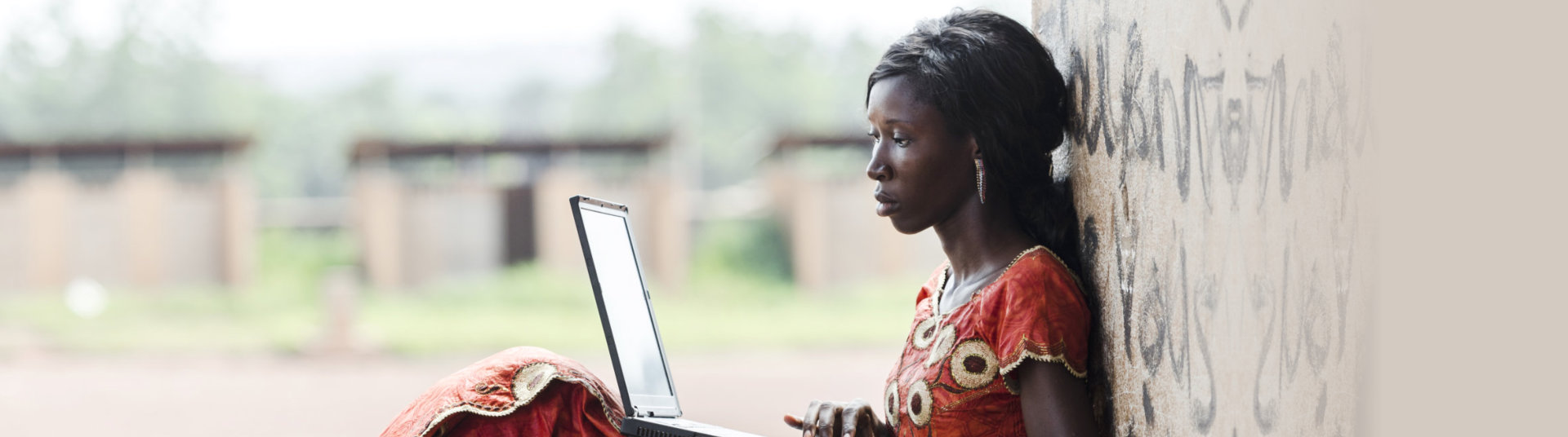 Barefoot African woman holding Laptop